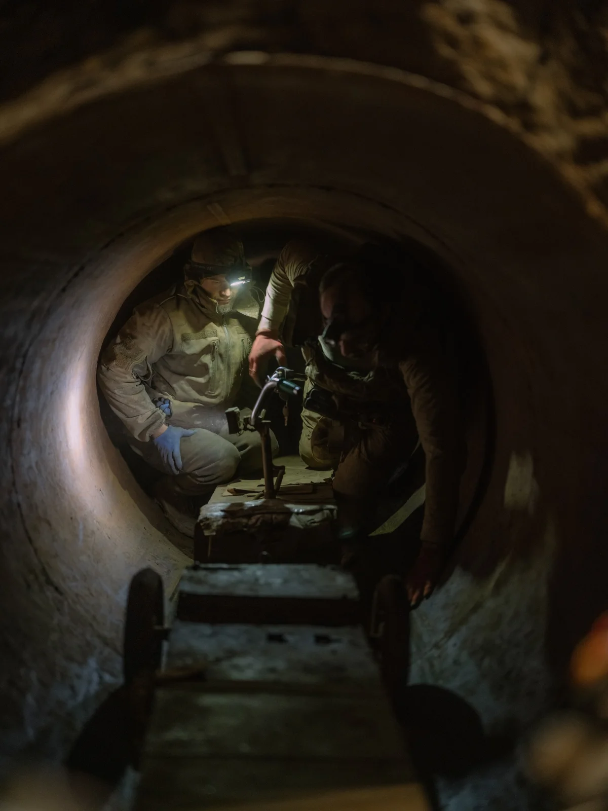 soldiers fix a scooter in a tunnel